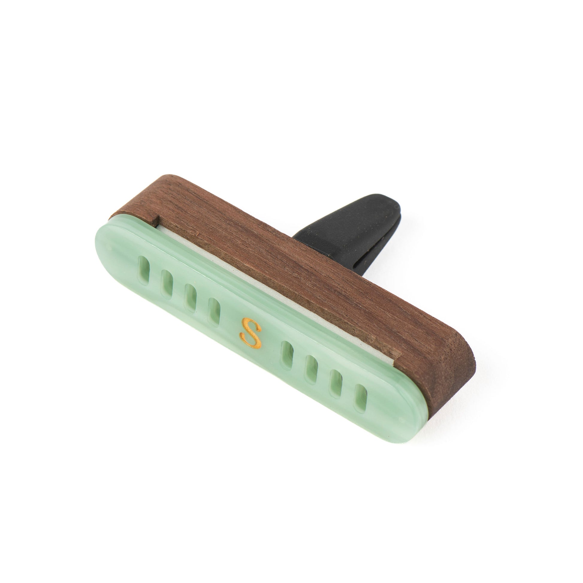 A light jade green car diffuser with a walnut wood case and a gold letter 'S' on the front, shown on a plain white background.