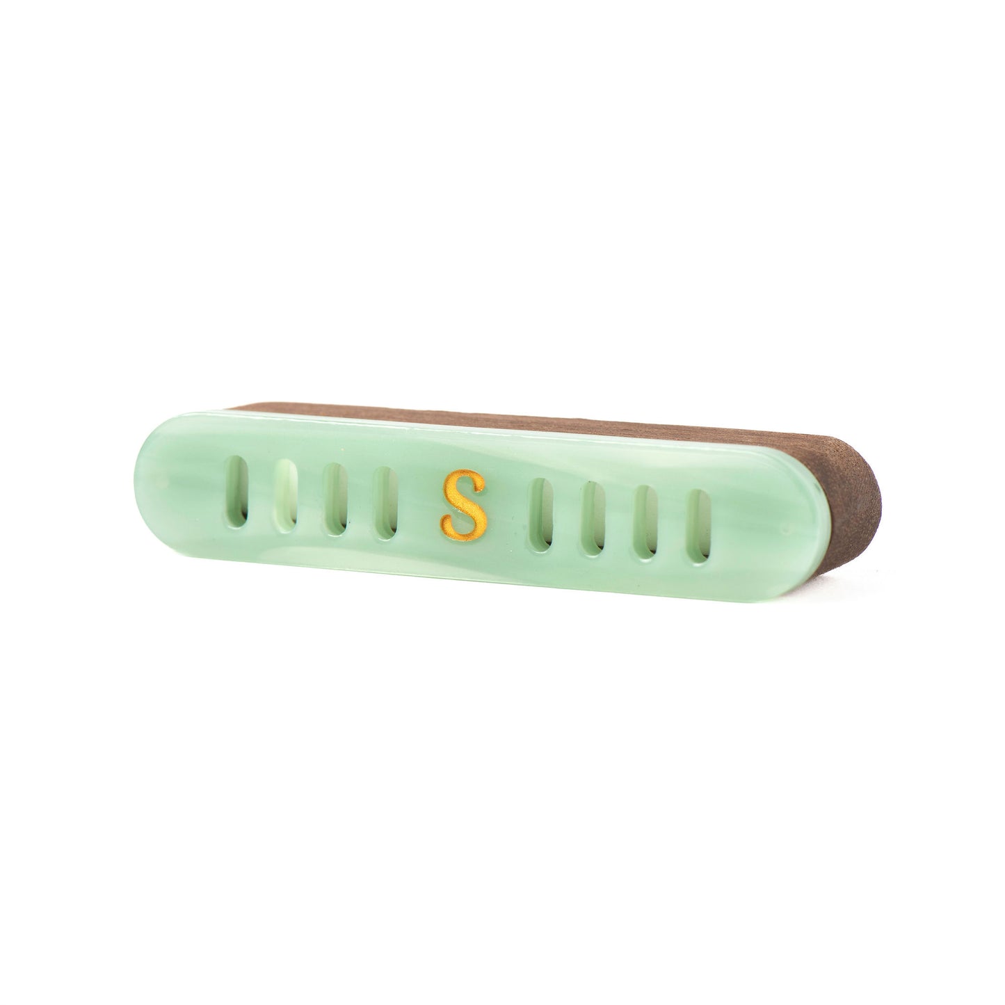 A light jade green car diffuser with a walnut wood case and a gold letter 'S' on the front, shown on a plain white background.
