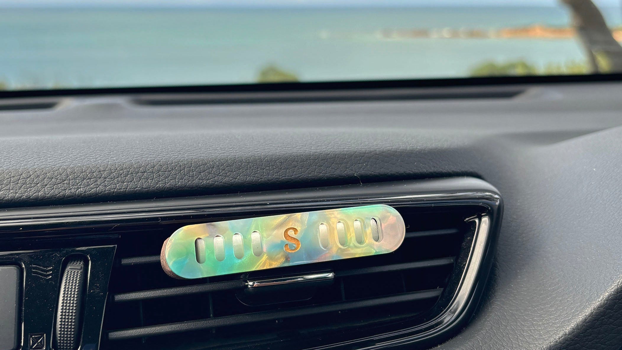 Scentopia essential oil car diffuser in the mermaid colourway shown in car vent