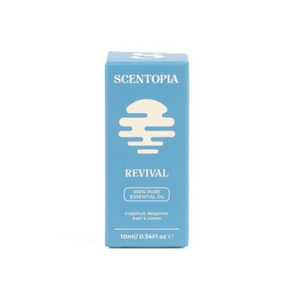 A light blue rectangular box of Scentopia Revival 100% pure essential oil, featuring a cream-colored dripping droplet logo and text, set against a plain white background.