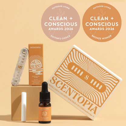 Scentopia essential oil car diffuser set with a Sunburst essential oil, and a white refill stick, arranged on a beige background with two award seals reading Clean + Conscious Awards 2026.